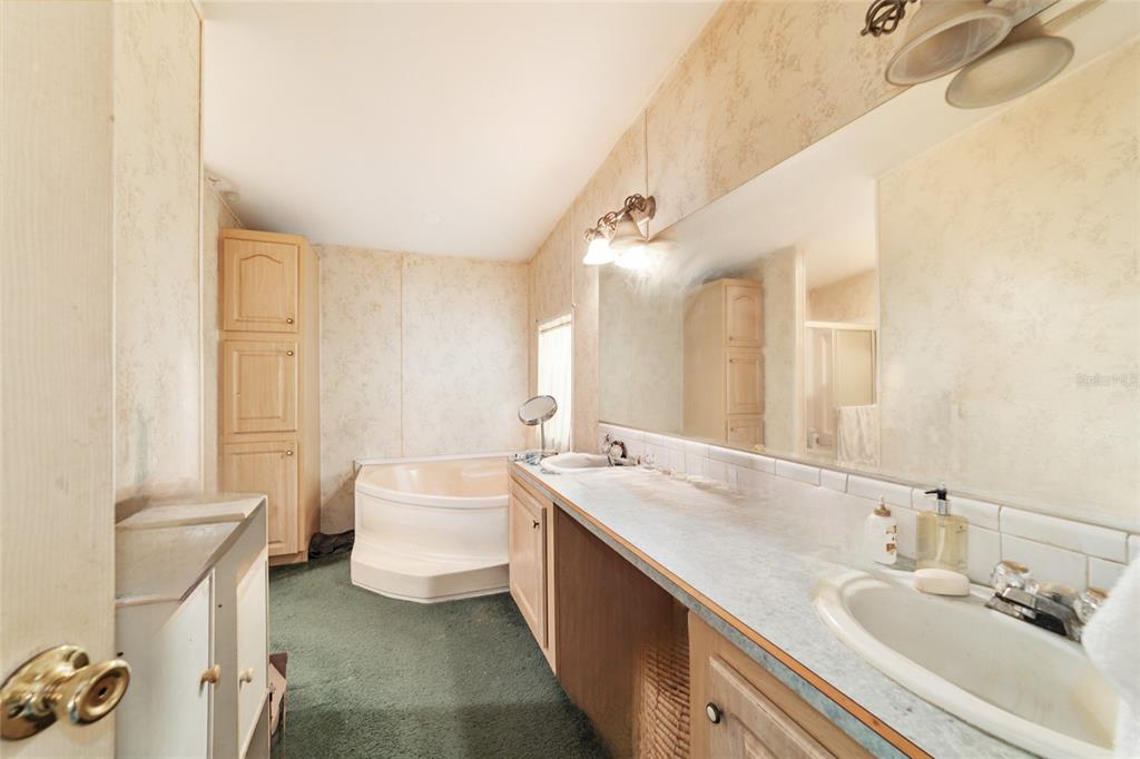 10630 Northwest 10th Street Road Ocala, FL 34482 - Photo 16 of 29 a spacious bathroom with a double vanity sink mirror and a bathtub