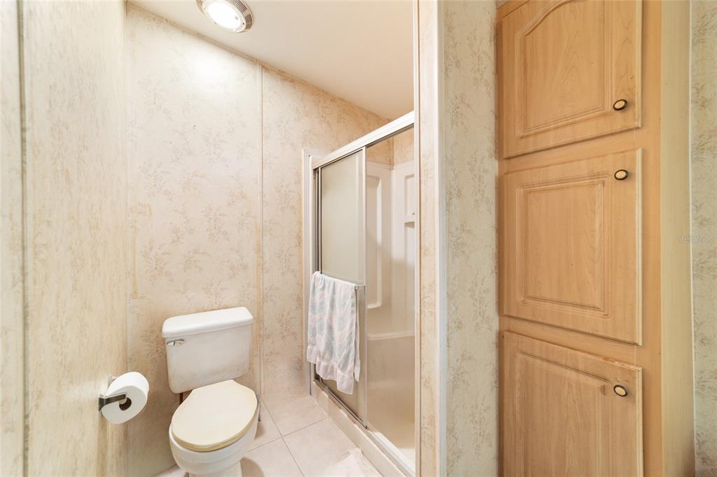 10630 Northwest 10th Street Road Ocala, FL 34482 - Photo 17 of 29 a white toilet sitting next to a shower