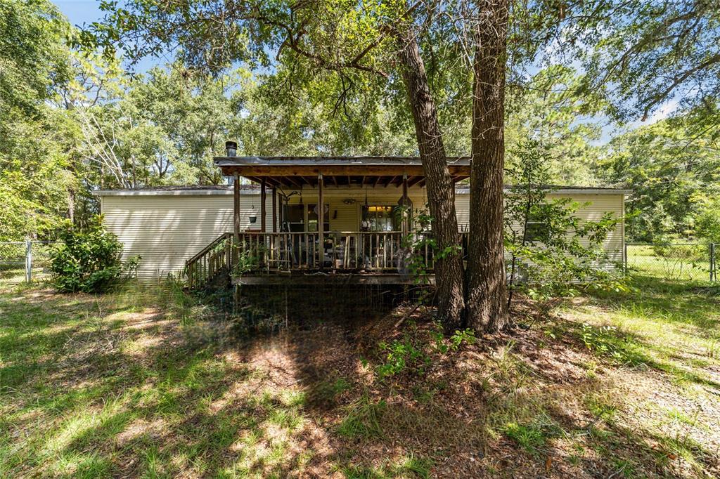 10630 Northwest 10th Street Road Ocala, FL 34482 - Photo 20 of 29 a view of house with large trees in the background