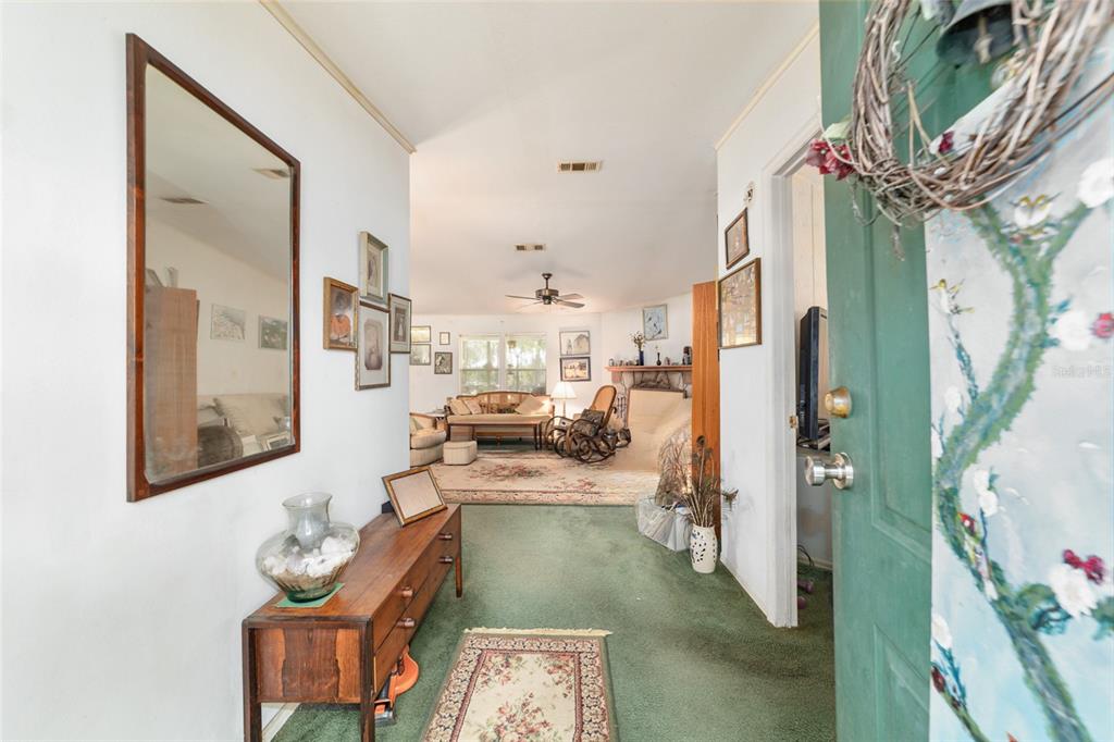 10630 Northwest 10th Street Road Ocala, FL 34482 - Photo 6 of 29 a living room with furniture and a chandelier