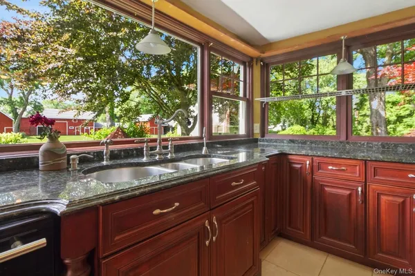 a kitchen with granite countertop a sink and a window