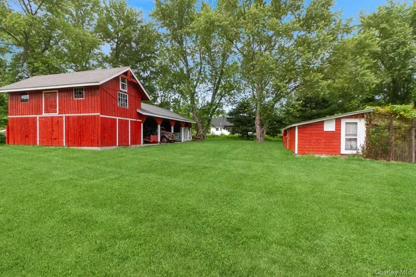 a view of a house with a yard and potted plants