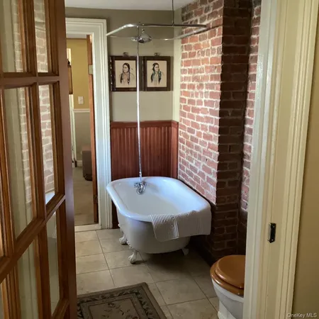a bathroom with a toilet a sink and a window