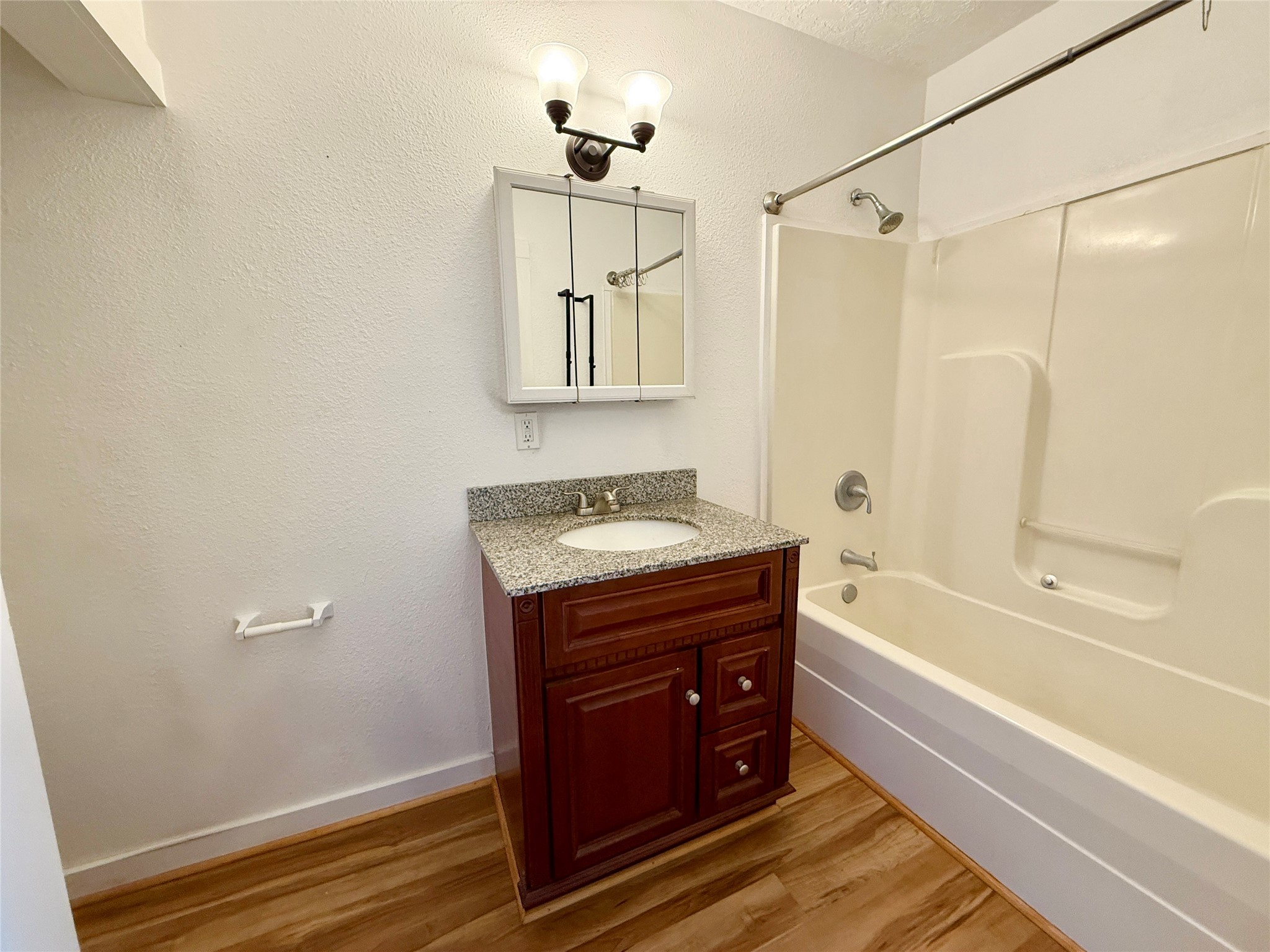 232 South Tesch Street, Unit 236 Bellville, TX 77418 - Photo 6 of 8 a bathroom with a tub sink and mirror