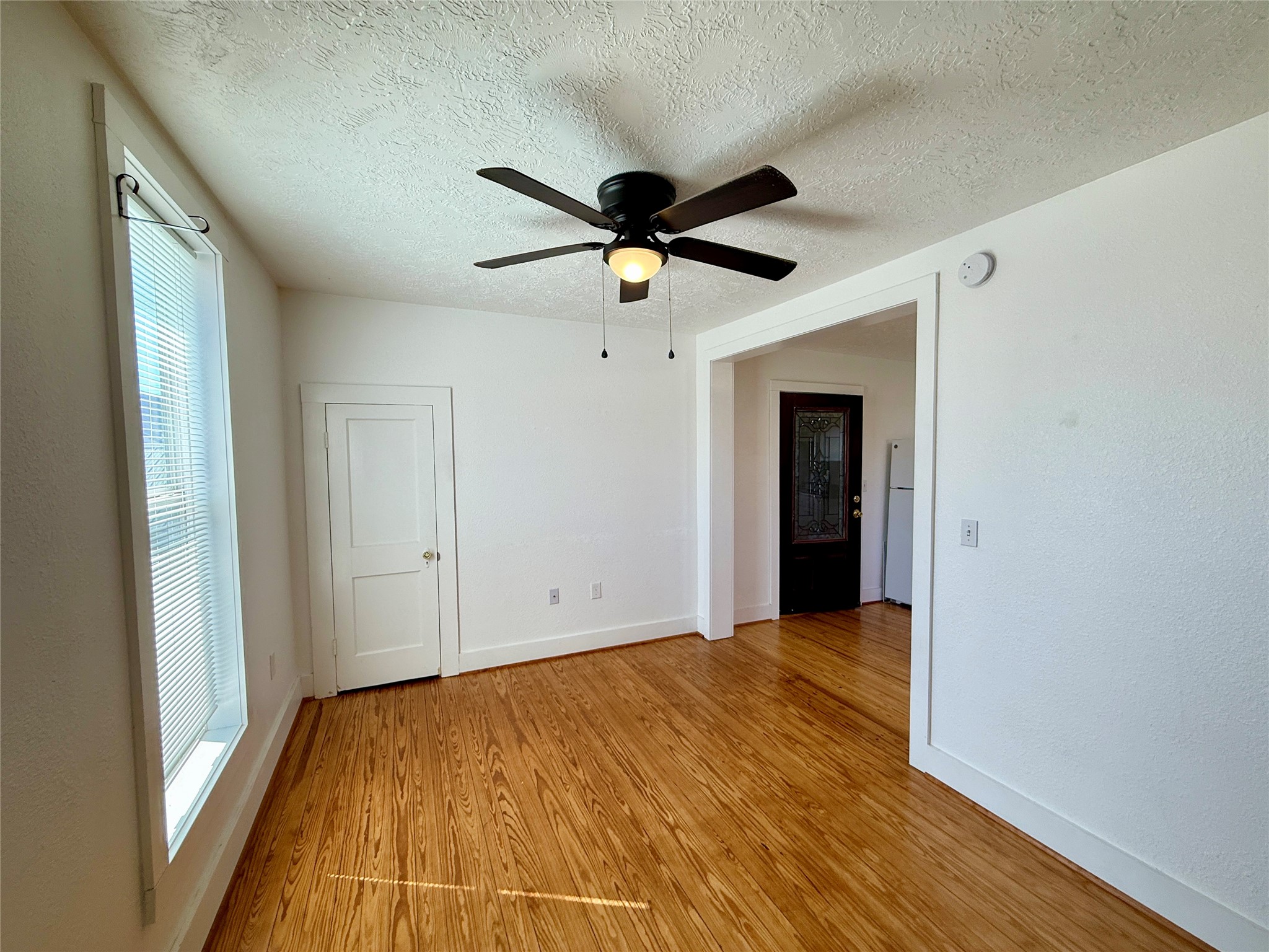 232 South Tesch Street, Unit 236 Bellville, TX 77418 - Photo 8 of 8 a view of a big room with wooden floor and a ceiling fan