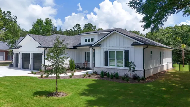 a front view of house with a garden