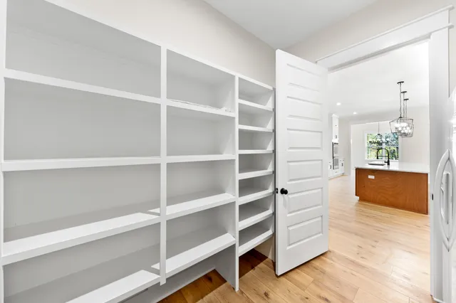 a view of a big room with wooden floor and a ceiling fan