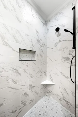 a group of lawn chairs under an umbrella in front of building