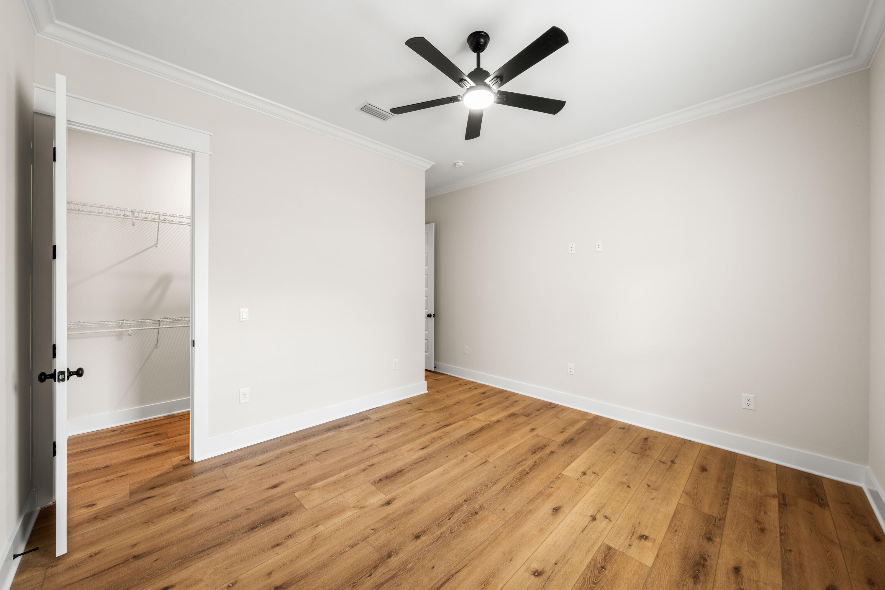 177 Harmony Way Freeport, FL 32439 - Photo 38 of 87 a view of a big room with wooden floor and a ceiling fan