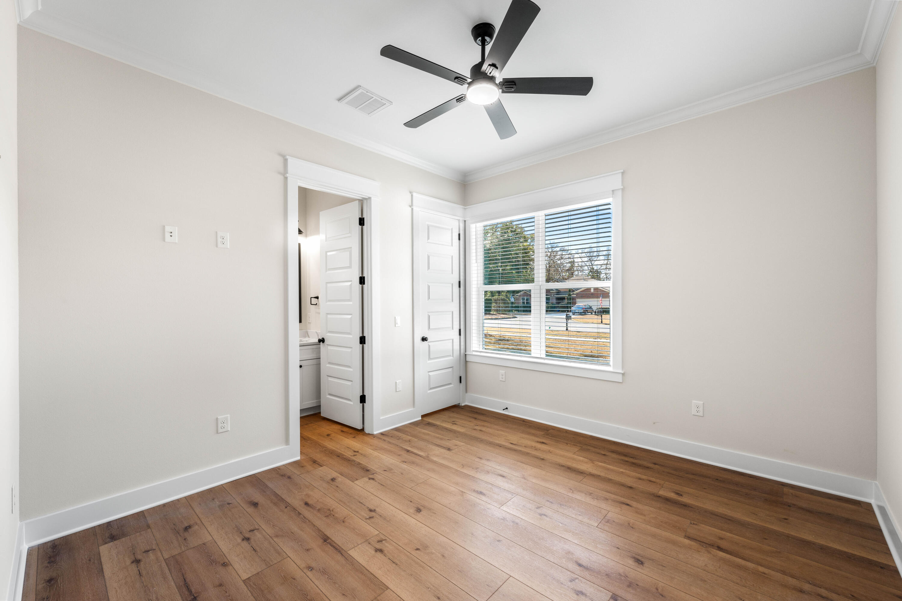 177 Harmony Way Freeport, FL 32439 - Photo 44 of 87 an empty room with wooden floor and windows