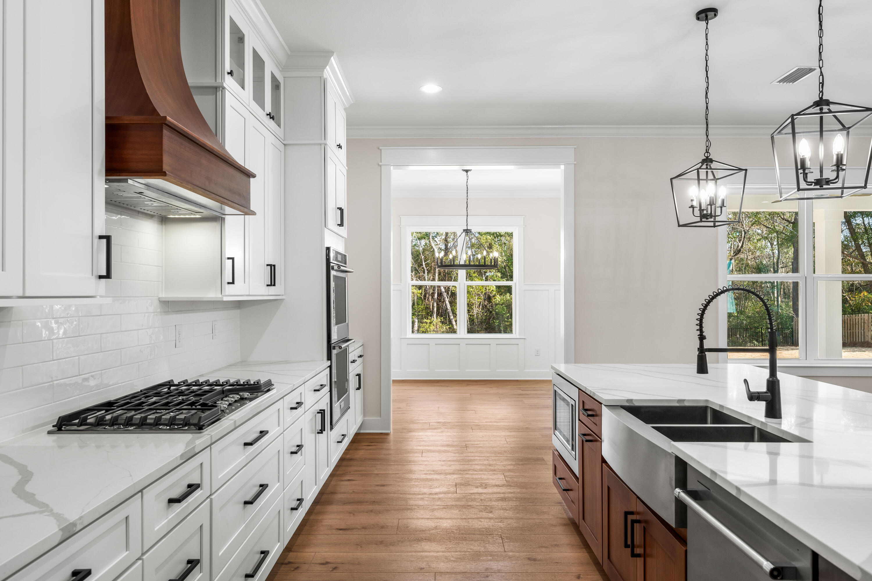 177 Harmony Way Freeport, FL 32439 - Photo 7 of 87 a kitchen with stainless steel appliances a sink a stove and a wooden floors