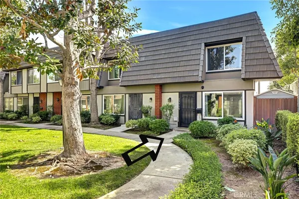 a view of a house with swimming pool and garden
