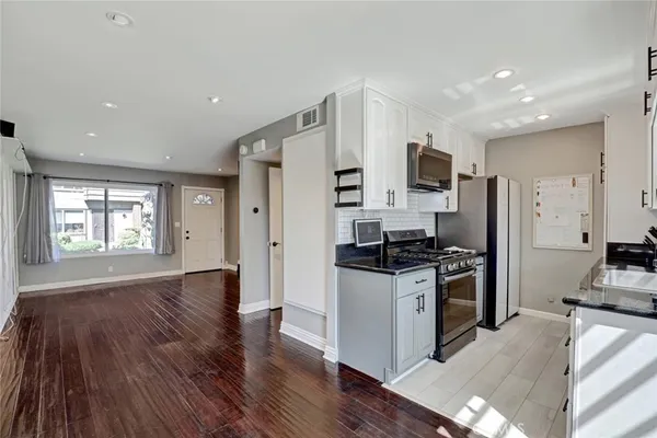a kitchen with stainless steel appliances granite countertop a stove and a refrigerator