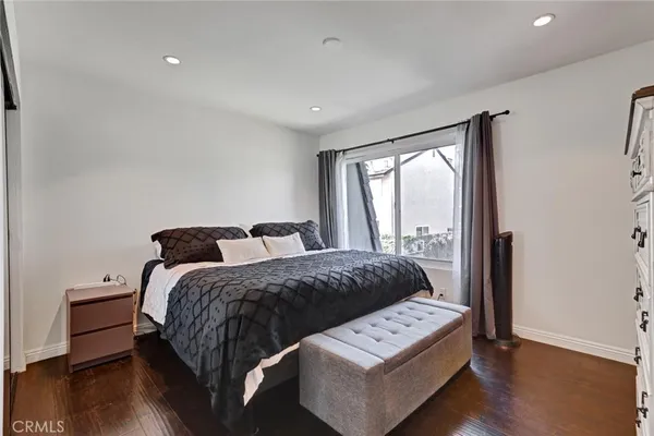 a spacious bedroom with a bed and a large window