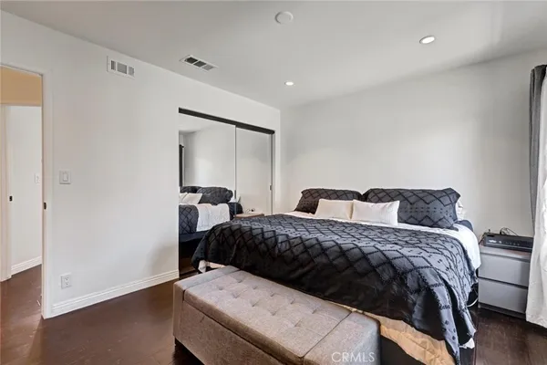 a bedroom with a bed and a mirror