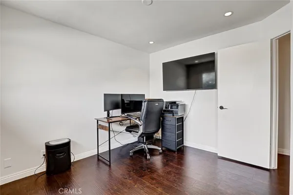 a view of a workspace with furniture and wooden floor