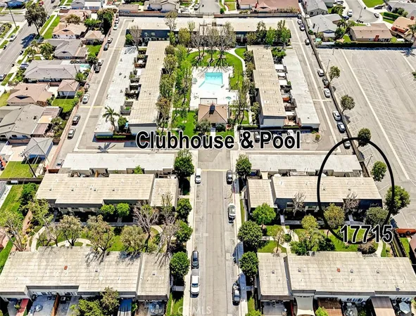 an aerial view of a house with a garden and lake view