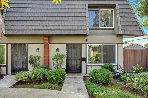 a view of a house with a yard and plants