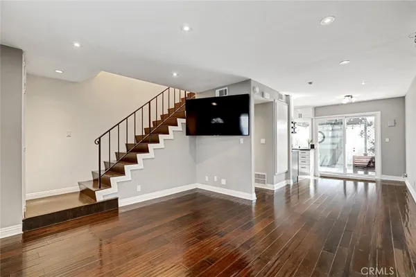 a view of entryway with wooden floor and stairs