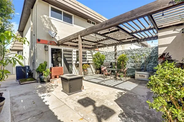 a view of a patio with a table and chairs and potted plants