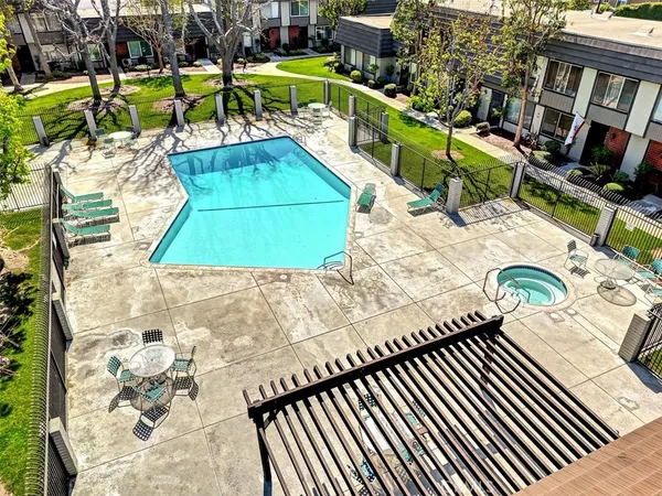 swimming pool view with a seating space