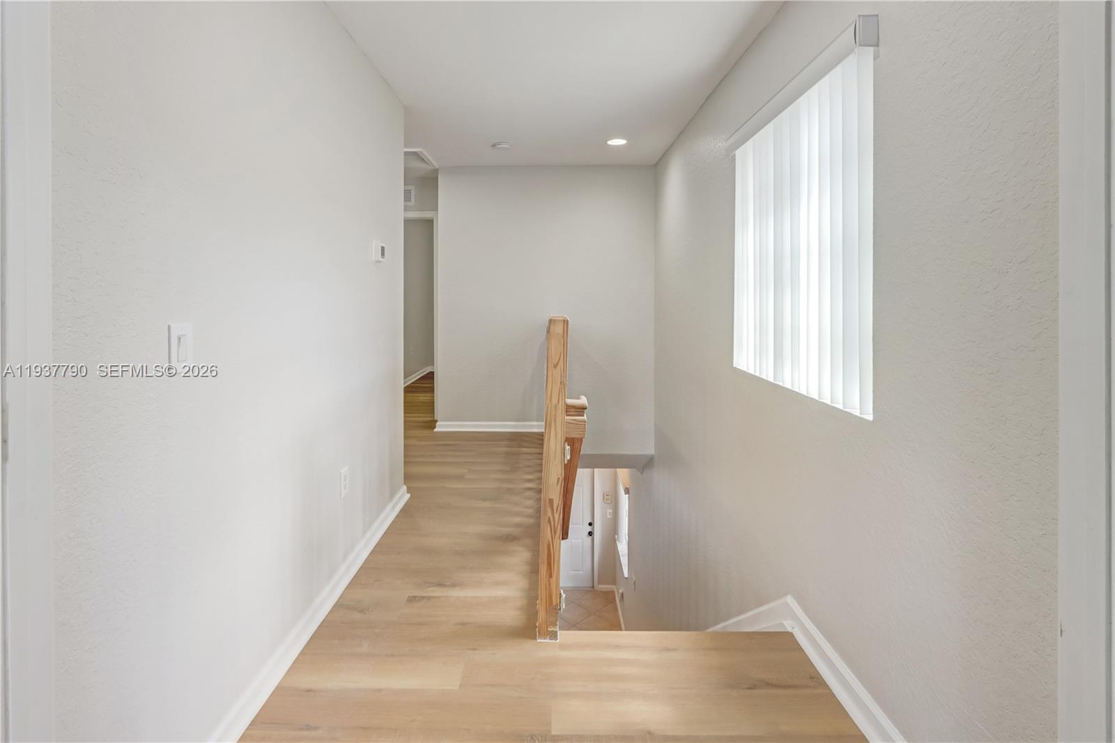 2830 Southwest 83rd Terrace, Unit 101 Miramar, FL 33025 - Photo 12 of 21 a view of a hallway with wooden floor and staircase