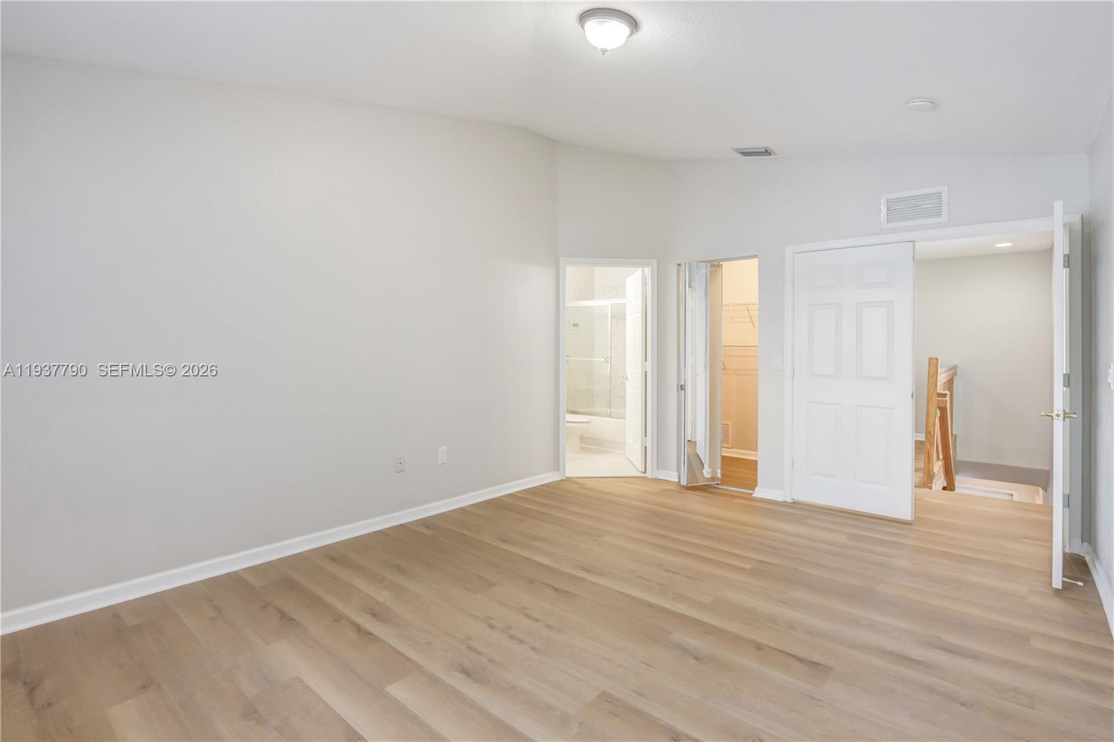2830 Southwest 83rd Terrace, Unit 101 Miramar, FL 33025 - Photo 14 of 21 a view of an empty room with wooden floor