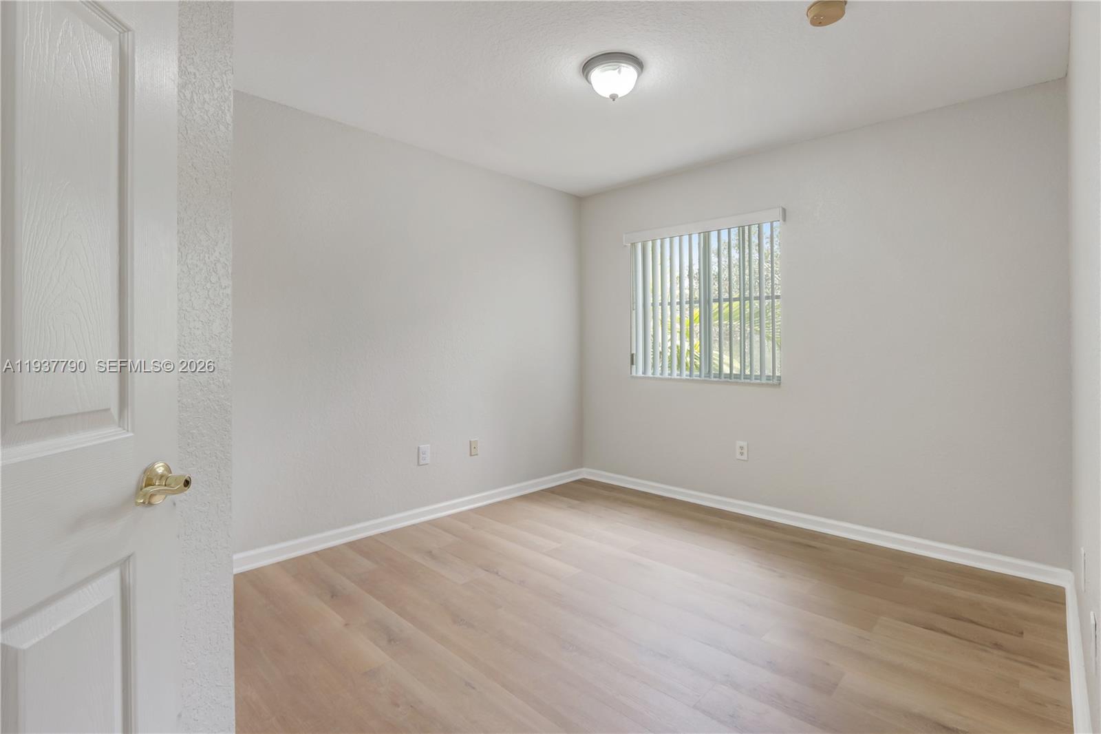 2830 Southwest 83rd Terrace, Unit 101 Miramar, FL 33025 - Photo 18 of 21 an empty room with a window