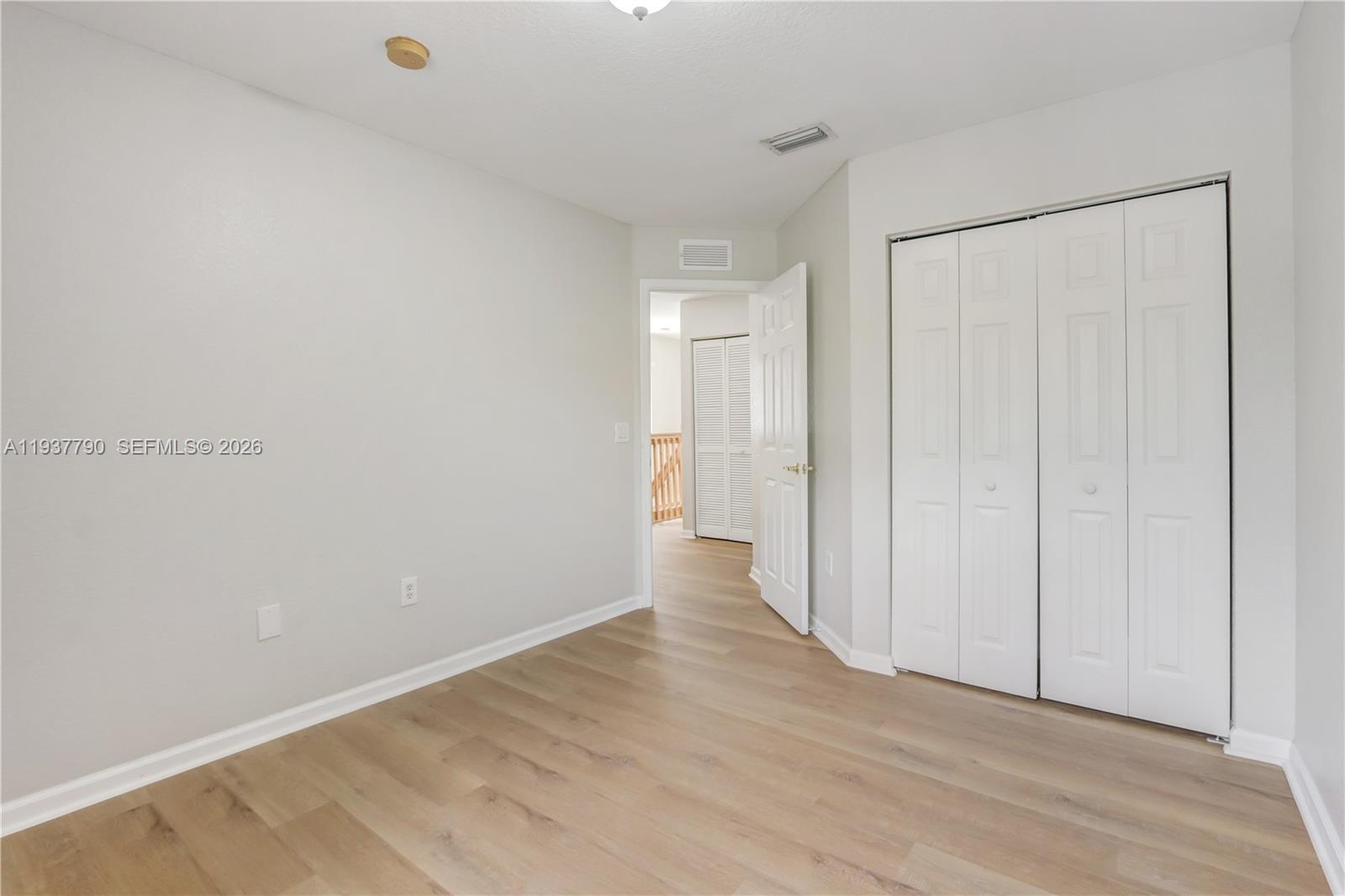 2830 Southwest 83rd Terrace, Unit 101 Miramar, FL 33025 - Photo 19 of 21 a view of an empty room with wooden floor