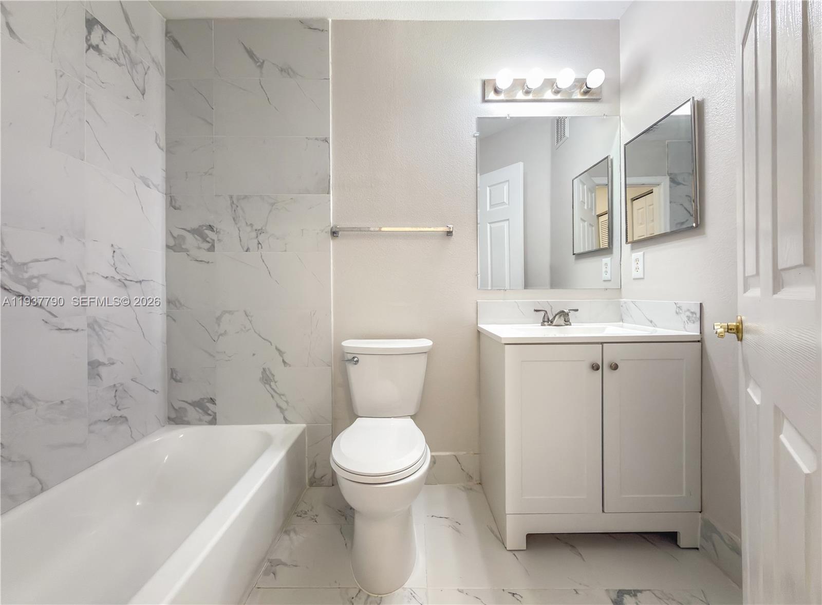 2830 Southwest 83rd Terrace, Unit 101 Miramar, FL 33025 - Photo 20 of 21 a bathroom with a toilet sink and bathtub