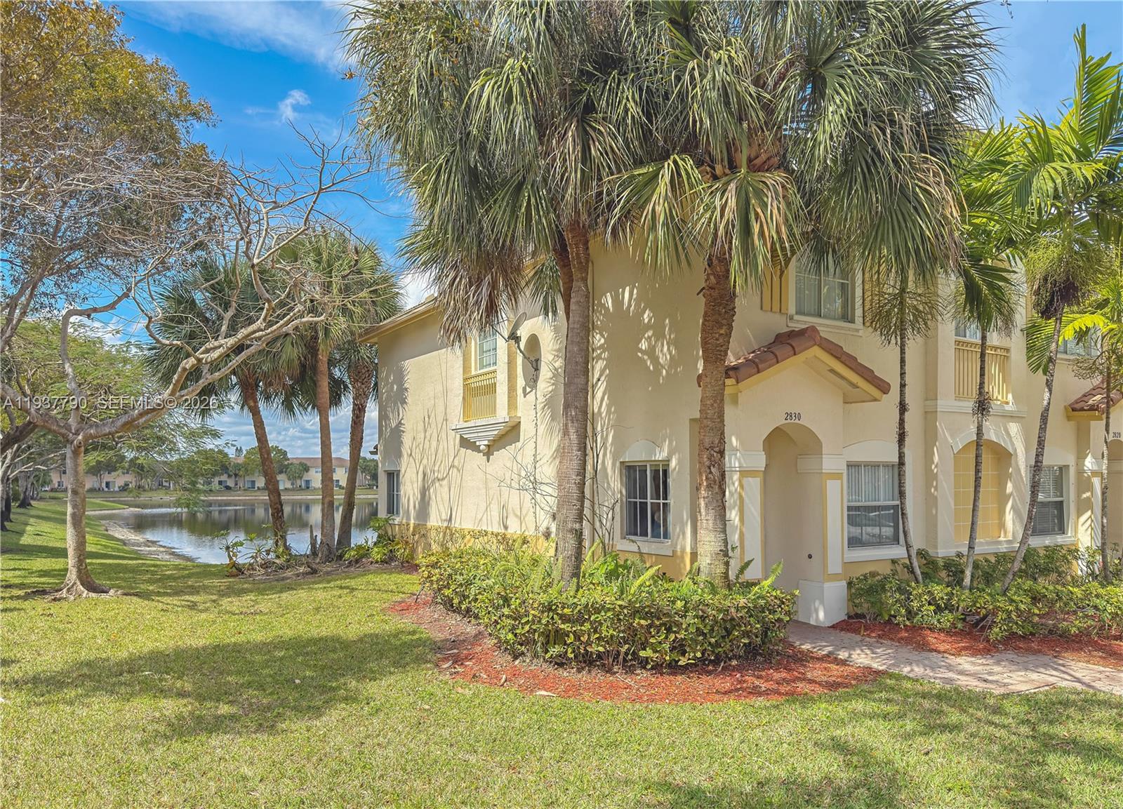 2830 Southwest 83rd Terrace, Unit 101 Miramar, FL 33025 - Photo 2 of 21 front view of a house with a garden