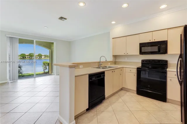 a kitchen with a stove top oven and cabinets
