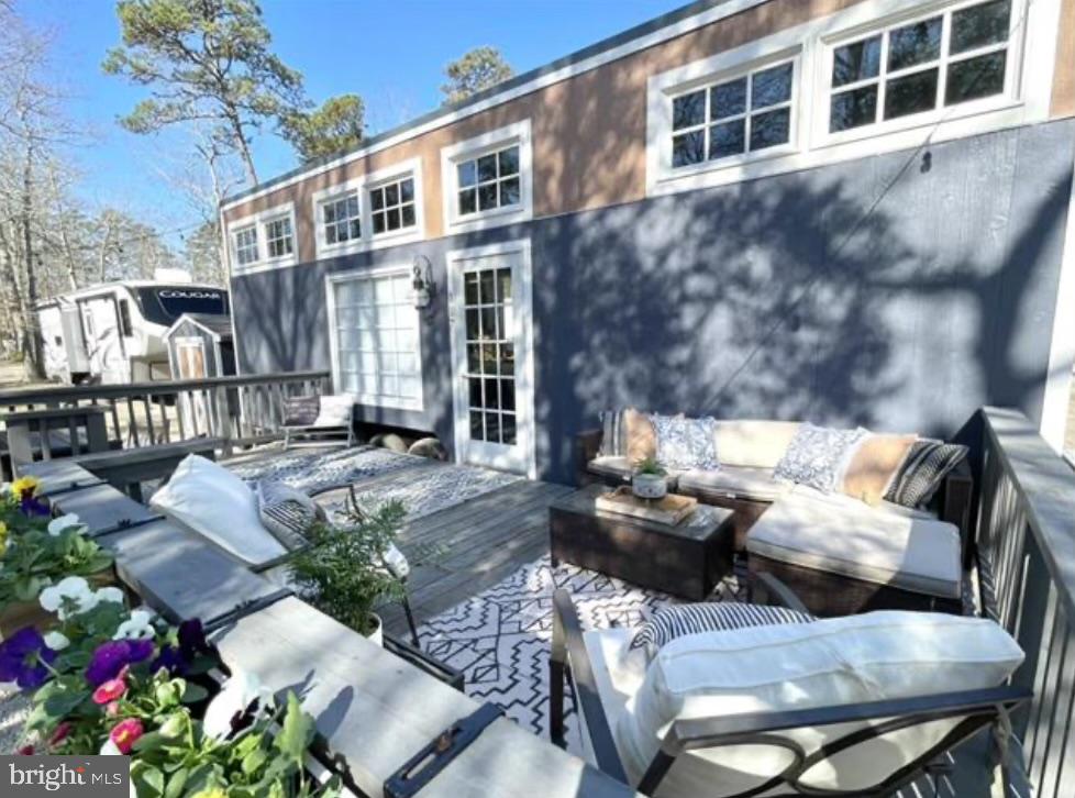 561 Corsons Tavern Road, Unit 43 Ocean View, NJ 08230 - Photo 2 of 18 a view of a patio with couches table and chairs and potted plants