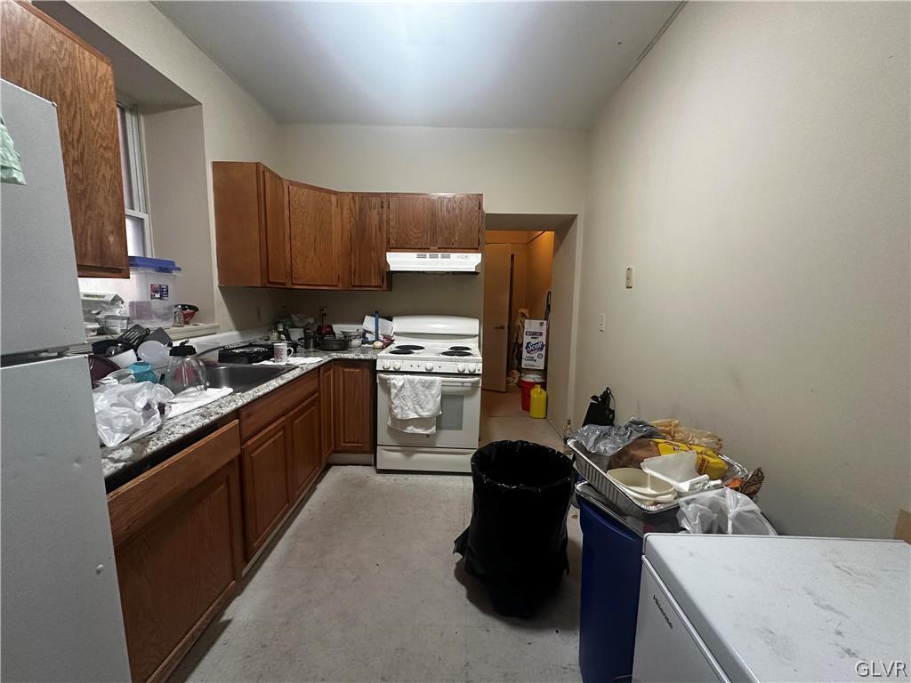 1306 East 4th Street Bethlehem, PA 18015 - Photo 17 of 47 a kitchen with a sink stove and refrigerator