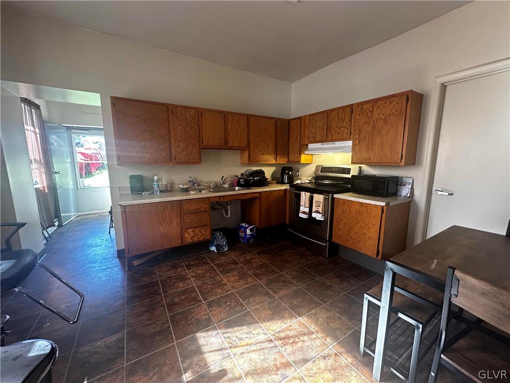 1306 East 4th Street Bethlehem, PA 18015 - Photo 21 of 47 a kitchen with stainless steel appliances a stove a sink and a refrigerator