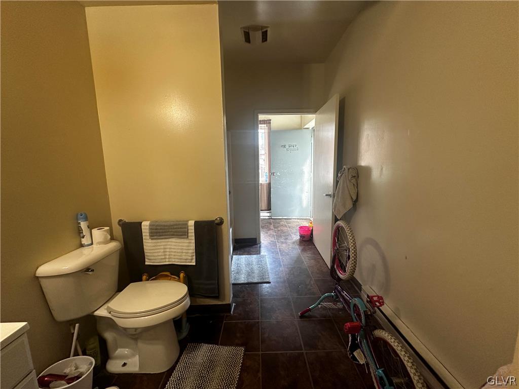1306 East 4th Street Bethlehem, PA 18015 - Photo 24 of 47 a bathroom with a toilet and a shower curtain