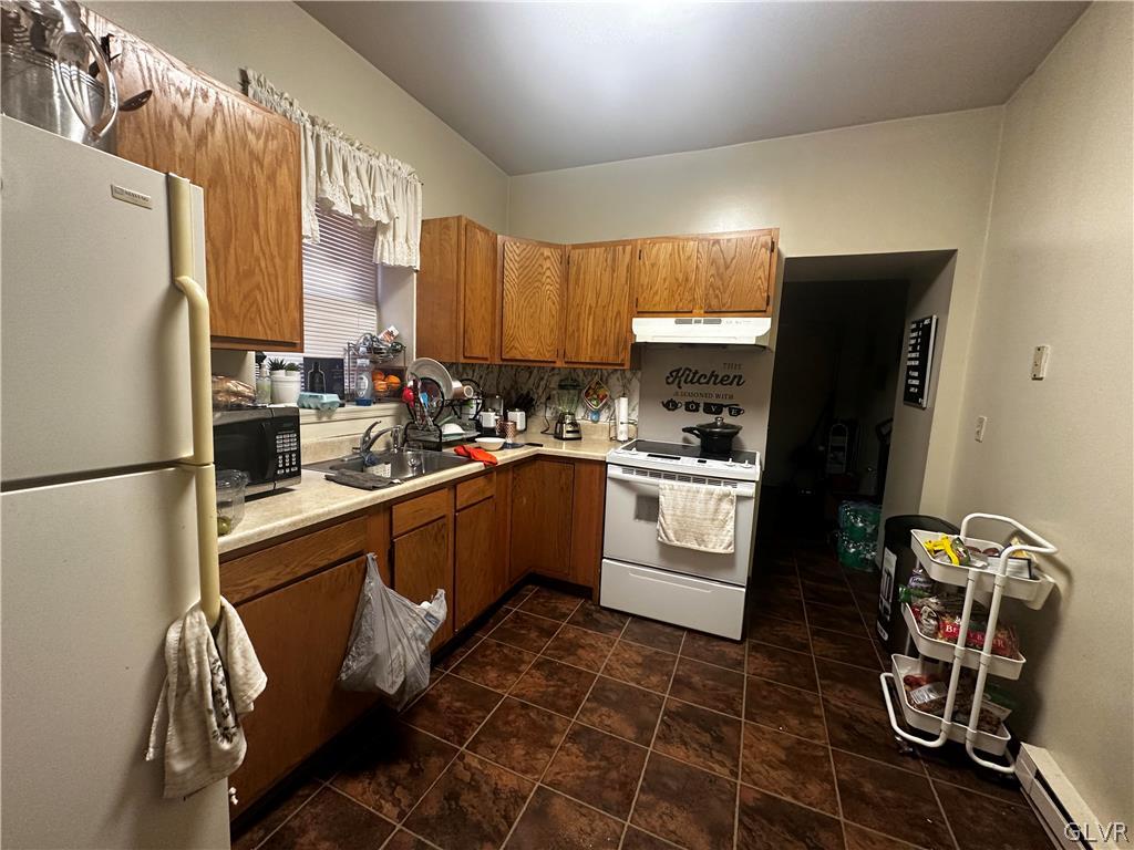 1306 East 4th Street Bethlehem, PA 18015 - Photo 33 of 47 a kitchen with a refrigerator a sink dishwasher and white cabinets with wooden floor