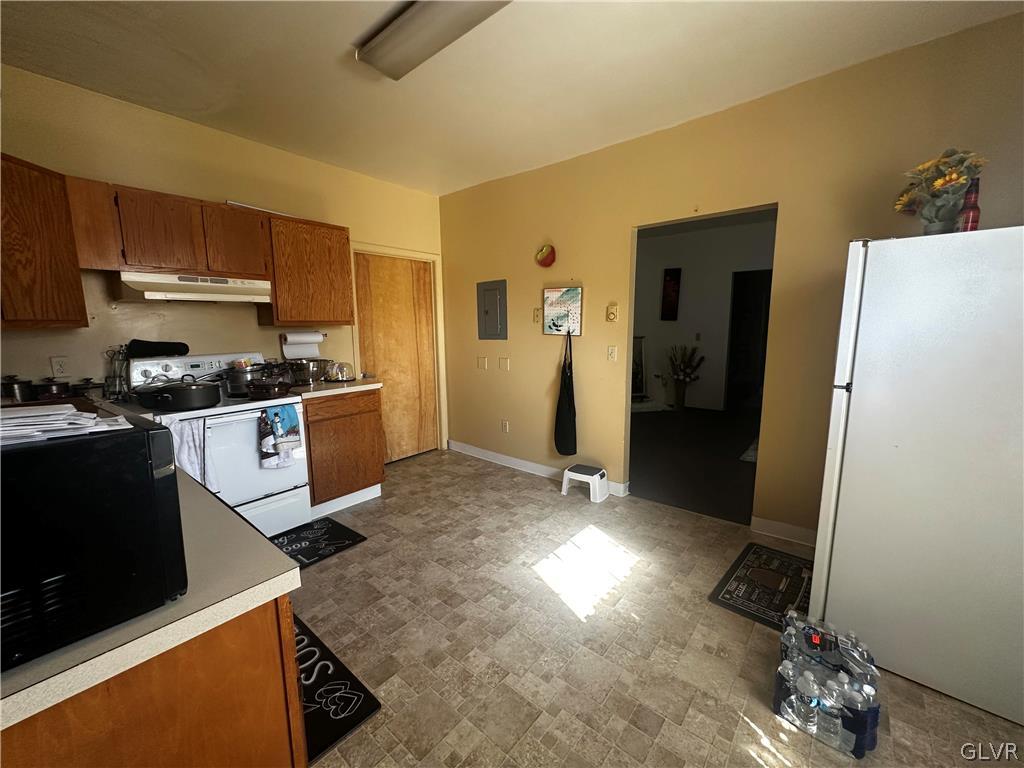 1306 East 4th Street Bethlehem, PA 18015 - Photo 39 of 47 a kitchen with granite countertop a refrigerator stove and sink