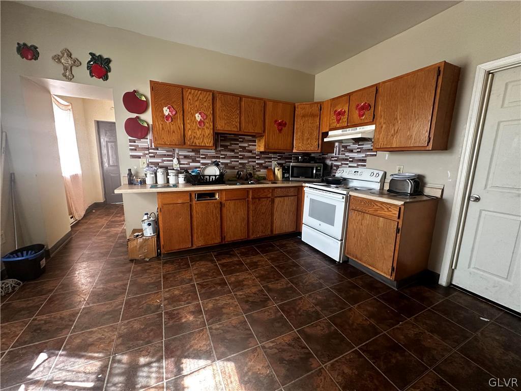 1306 East 4th Street Bethlehem, PA 18015 - Photo 44 of 47 a kitchen with stainless steel appliances a sink a stove a refrigerator and cabinets