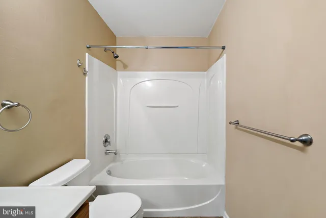 a bathroom with a shower and a toilet