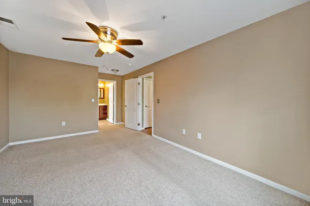 a bathroom with a toilet sink vanity and mirror