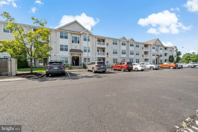 a view of a cars park in front of a building