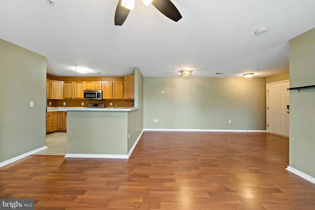 a view of a kitchen with a sink hardwood floor and a window