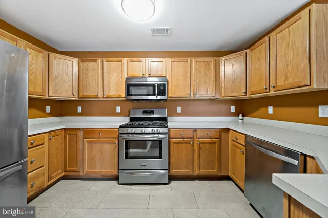 a kitchen with stainless steel appliances granite countertop a stove sink and microwave