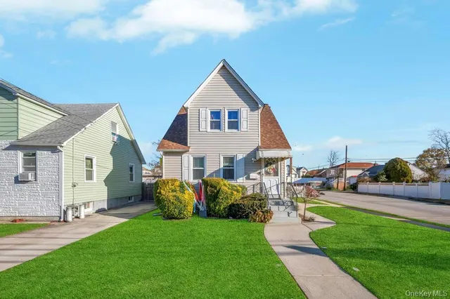a front view of house with yard and green space