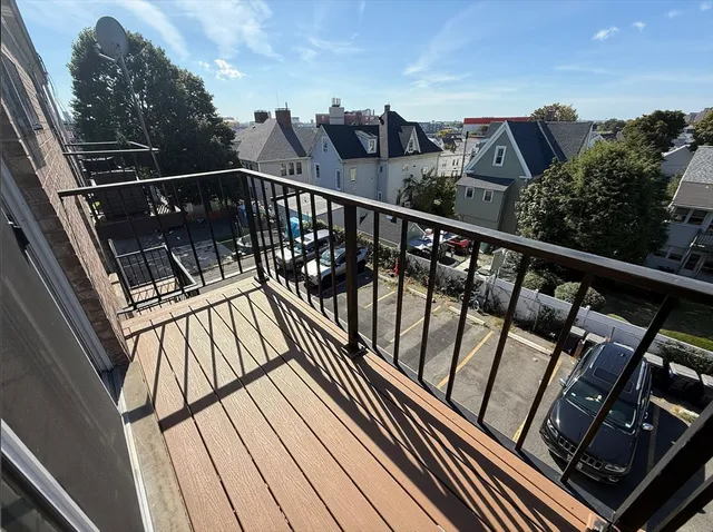 a view of balcony with wooden floor and fence