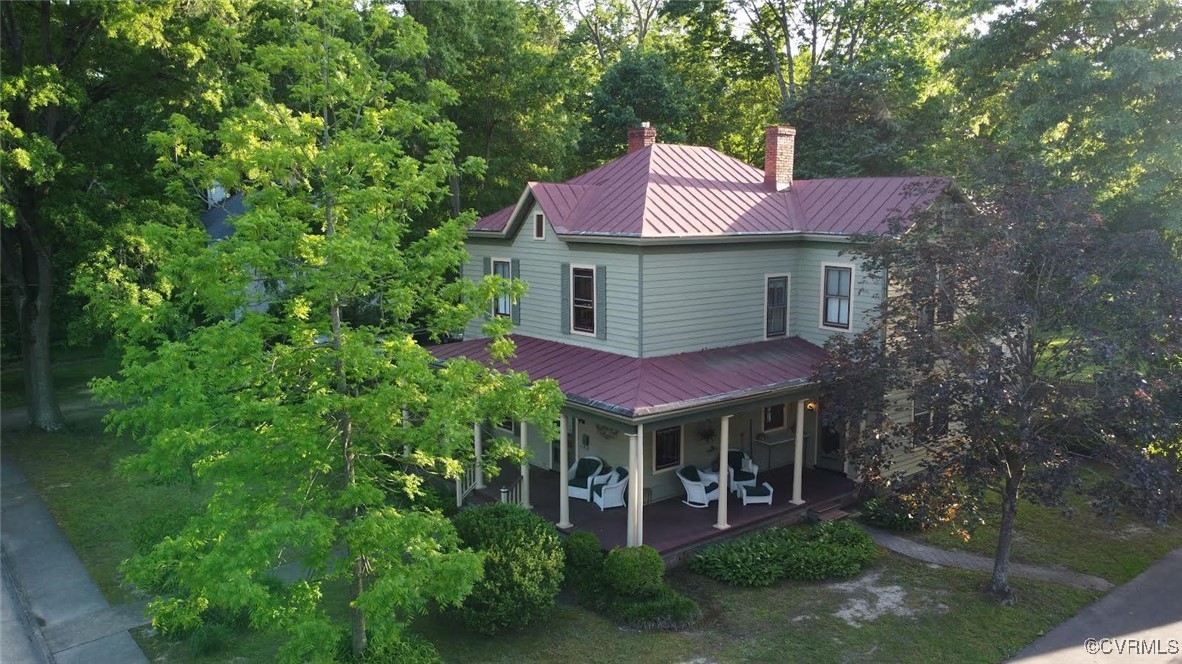 a front view of a house with yard and trees