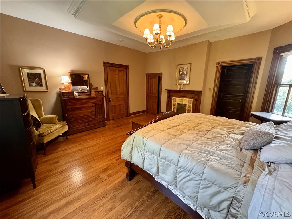 600 Virginia Street Ashland, VA 23005 - Photo 14 of 33 a spacious bedroom with a bed and dresser with wooden floor