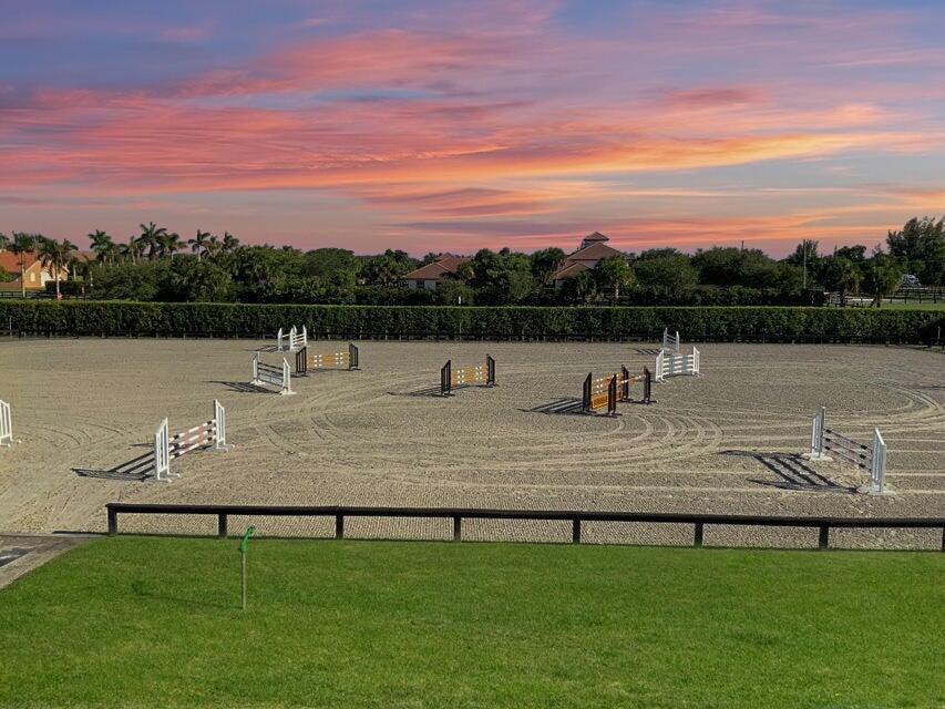 a view of swimming pool with seating area and yard