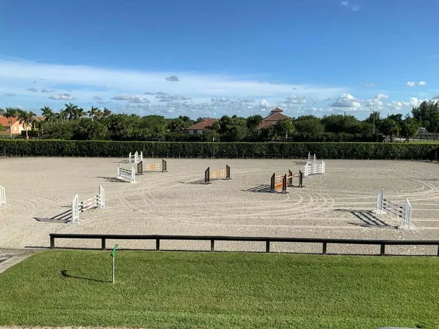 a view of swimming pool with seating area and lake view